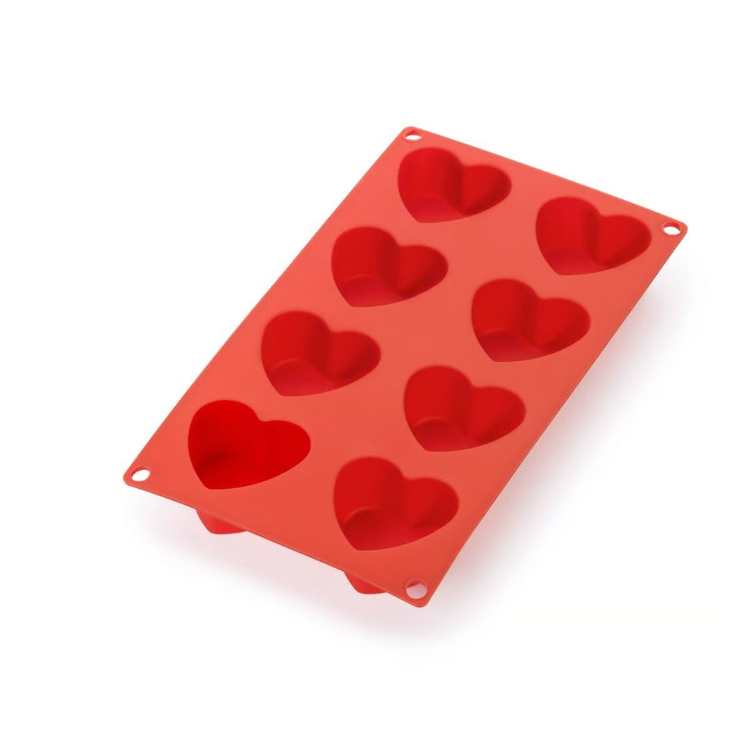 Red silicone heart-shaped mold on a white background